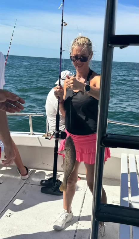 Guest showing her catch on board during a fishing trip in Punta del Este
